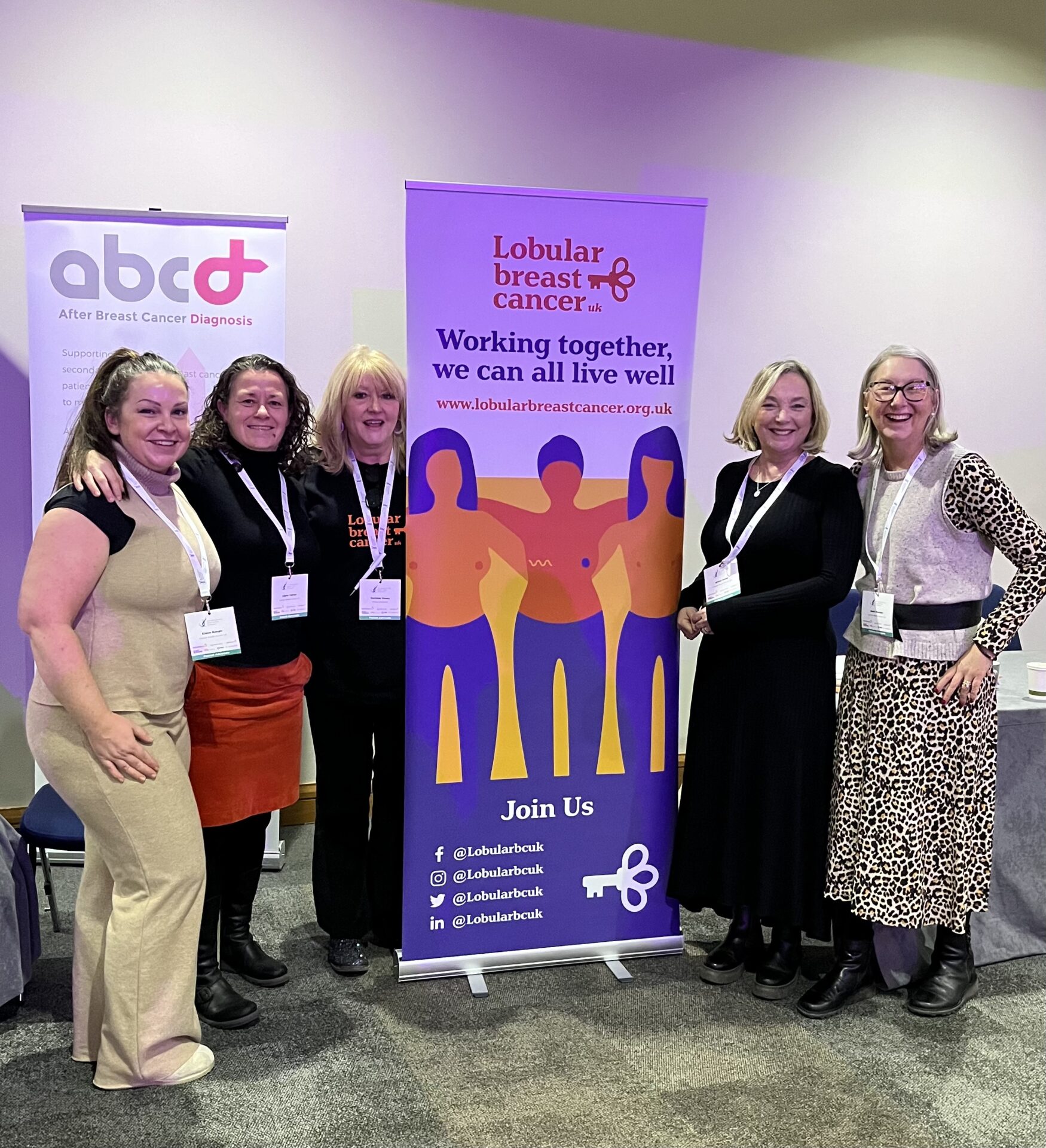 Five women standing next to a banner that reads Lobular Breast Cancer UK