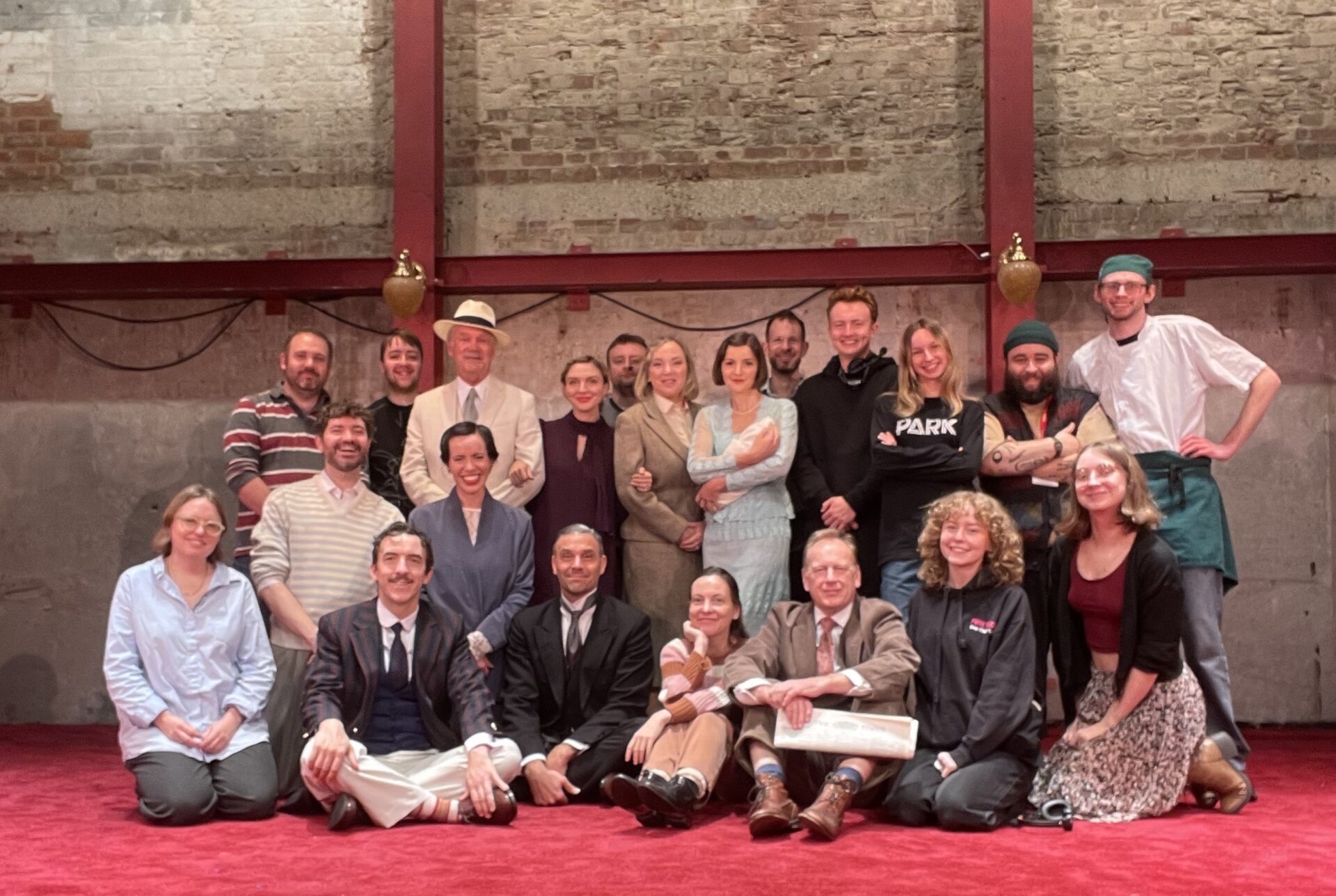 22 cast and crew from The Forsyte Saga at Park Theatre London sit and stand together in the theatre to demonstrate the 22 women diagnosed with Lobular Breast Cancer every day in the UK.