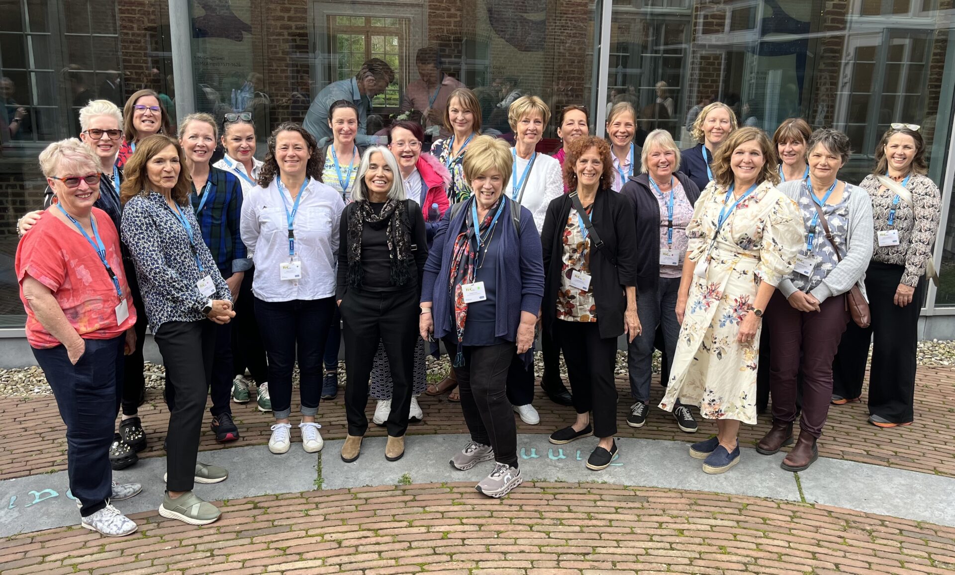 22 women all who had a Lobular Breast Cancer diagnosis stand together representing the 22 women diagnosed with Lobular every day in the UK.