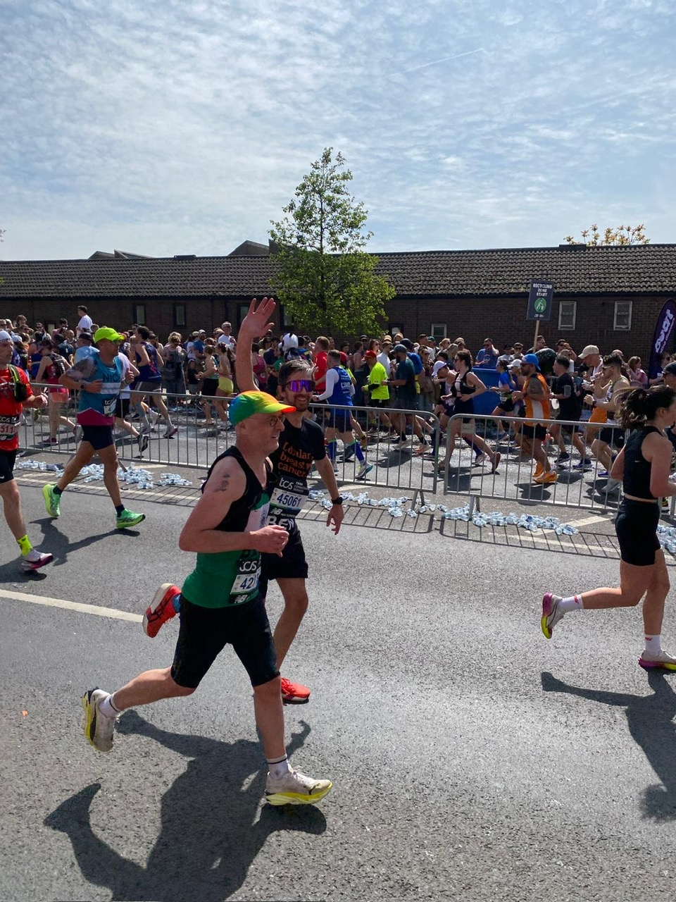 Ben running the London Marathon and waving at the crowd